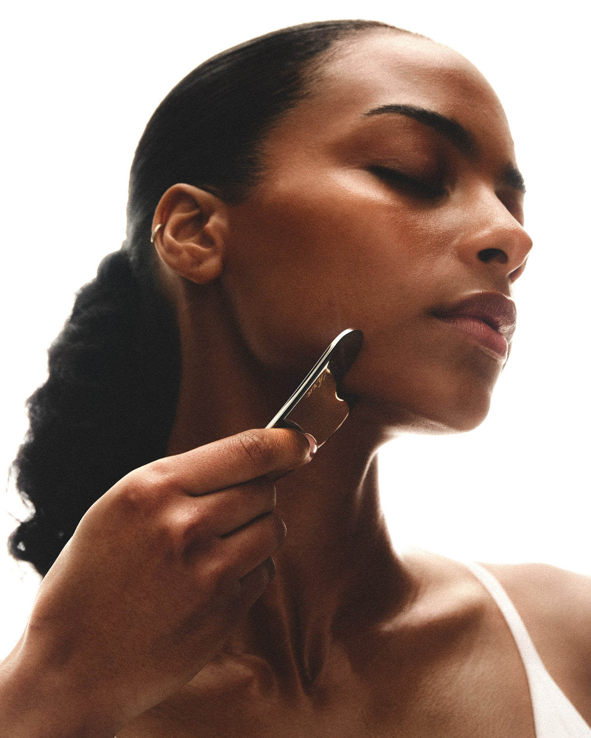 Profile with the stainless steel gua sha along the jaw