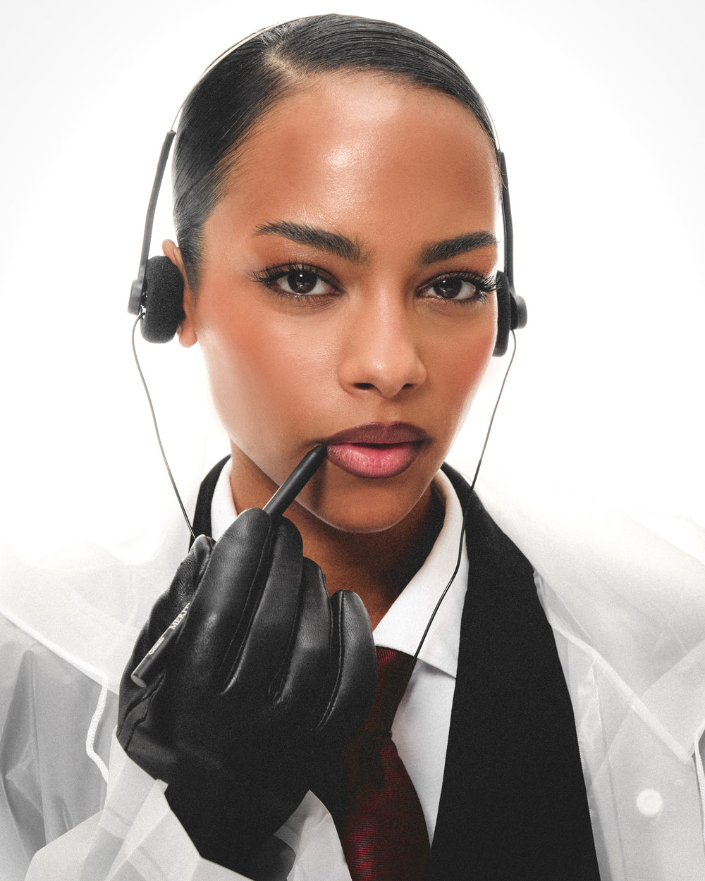 Model in black gloves holding the Merithra lip pencil