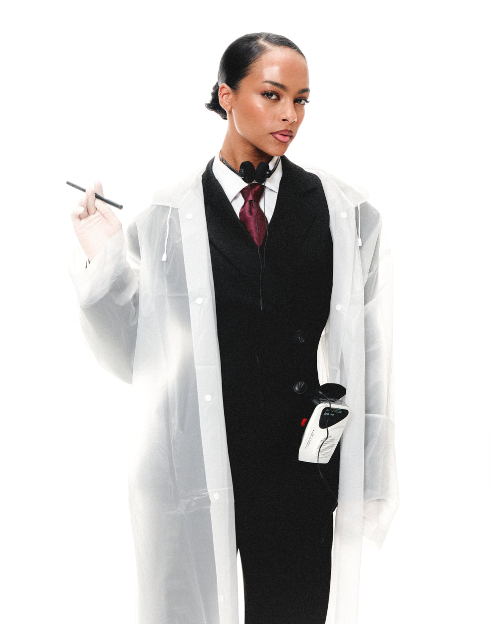 Model in a clear lab coat over a black suit