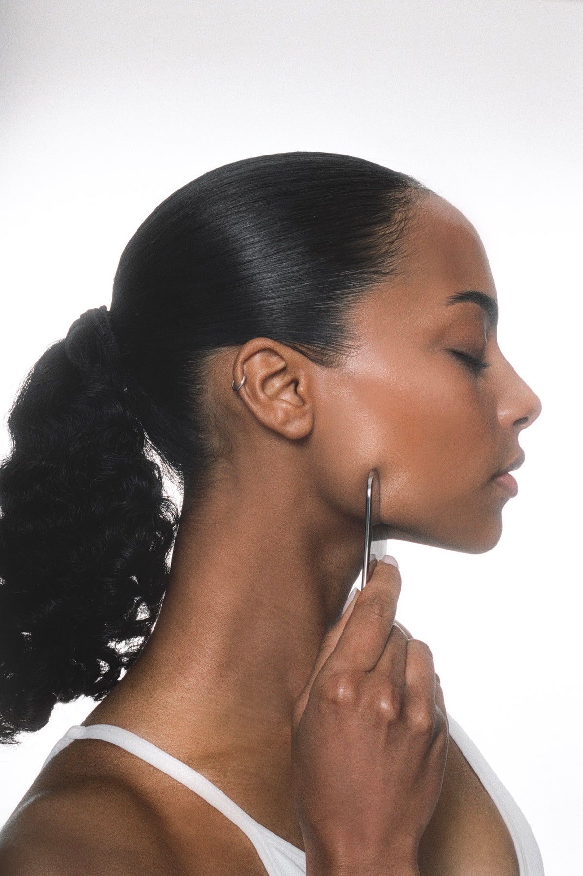 Gua sha along the cheekbone